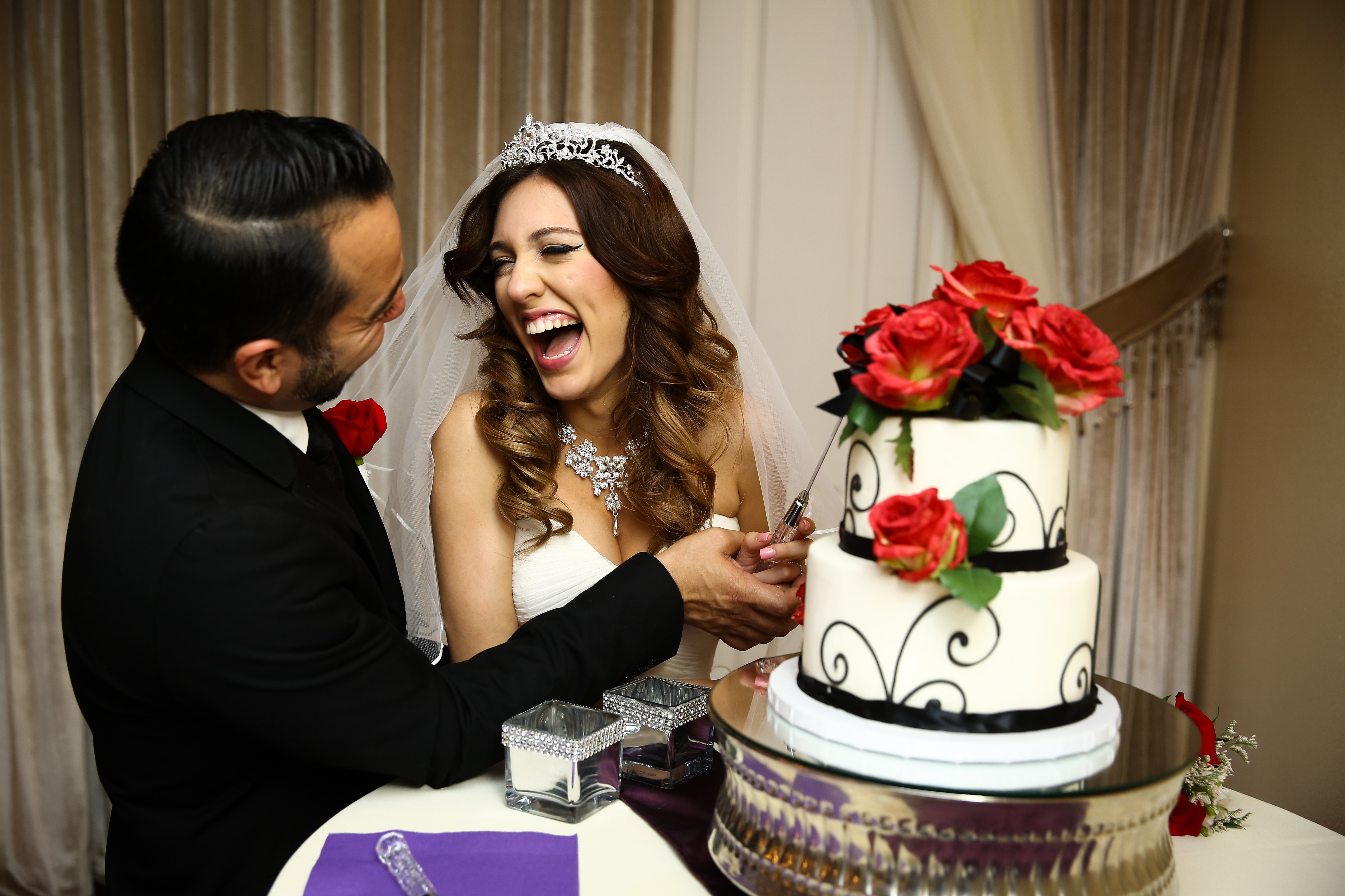 A happy couple cutting their wedding cake at their reception in Las Vegas